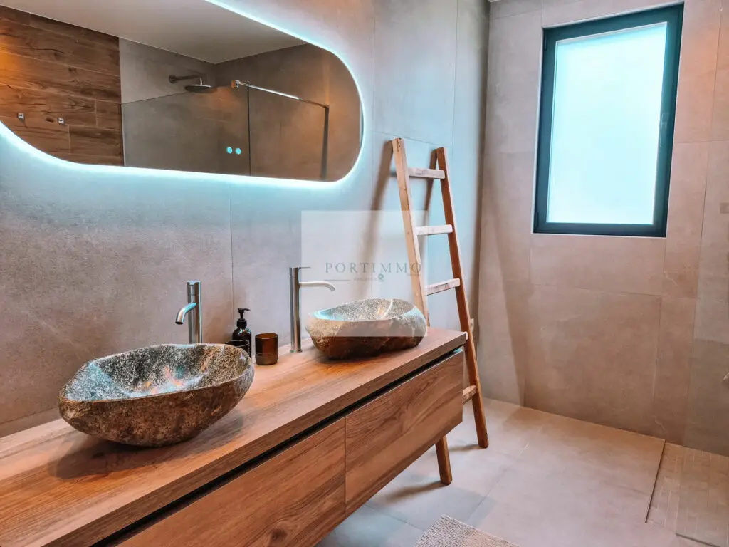 Bathroom with natural stone basins and wooden vanity
